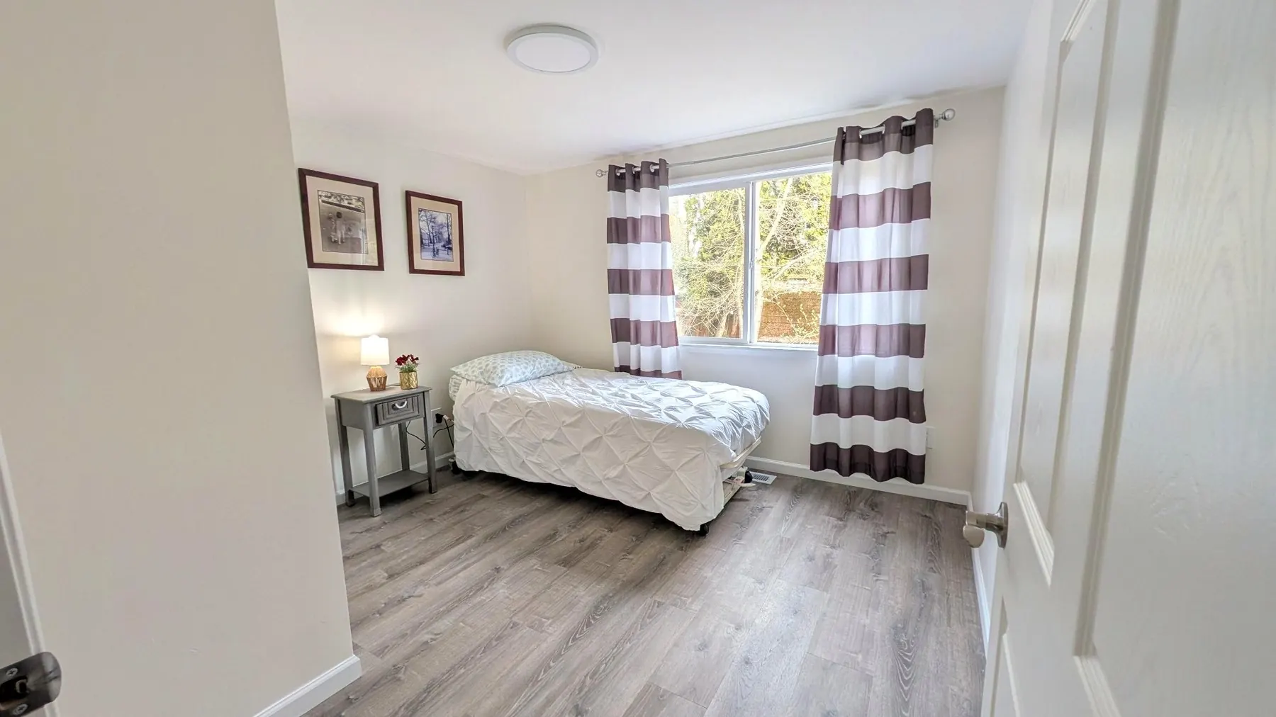 Resident bedroom with natural light at Rest Assured AFH